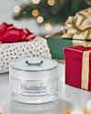 a jar of face cream and a gift box