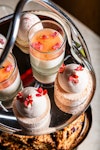 a tray of desserts with flowers on top
