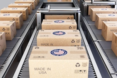  Sealed cardboard boxes labeled with "Made in USA" sit on a conveyor belt. 