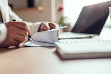 man going through contract at desk