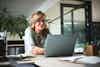 a woman sitting at a desk with a laptop